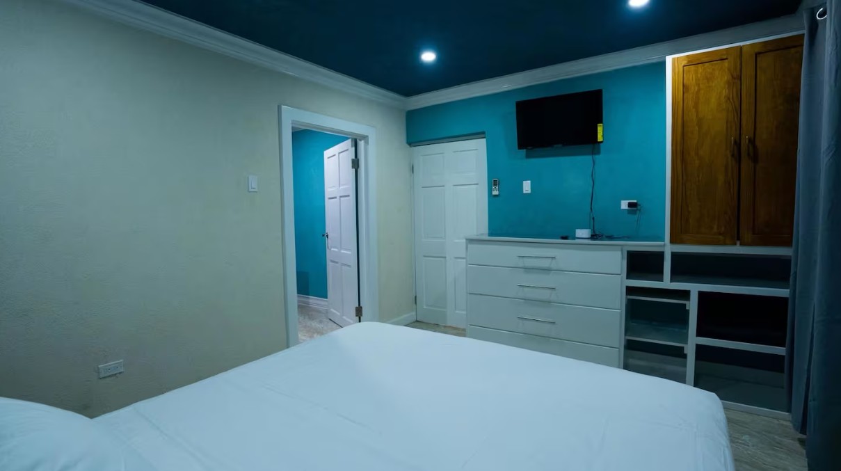Bedroom storage wall with wardrobe and teal paint