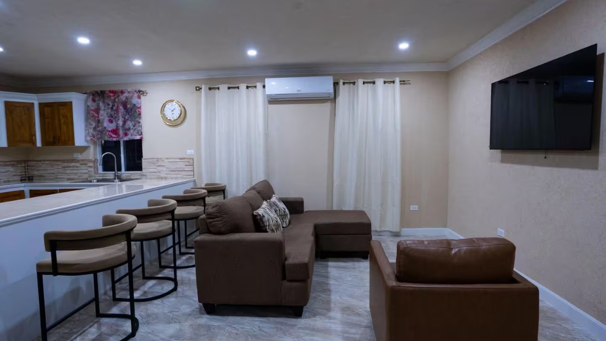 Living room with brown sectional sofa and wall-mounted TV
